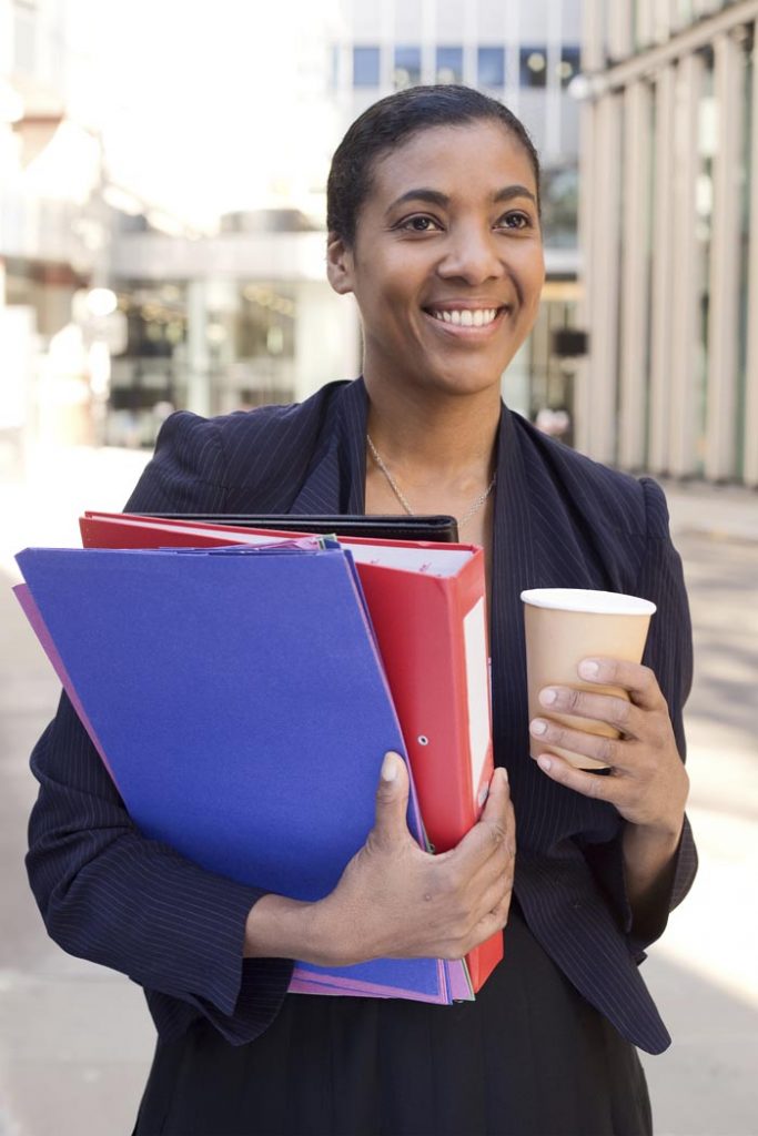 Business woman with a coffee and folders.